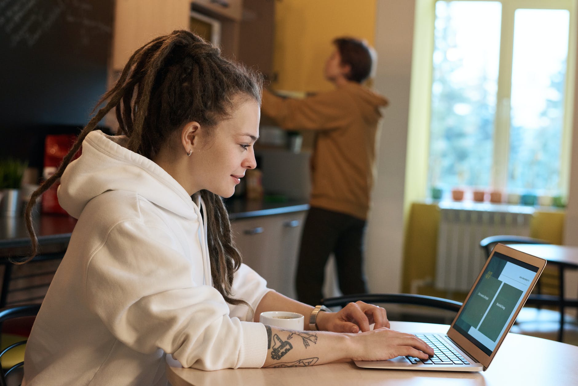 shallow focus photo of woman using a laptop